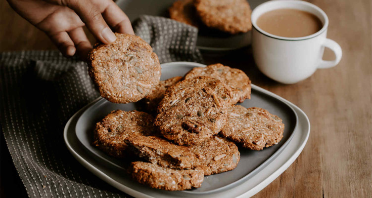 hand grabbing cookies and coffee