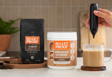 Hand frothing a mug of Bulletproof coffee with Hazelnut creamer