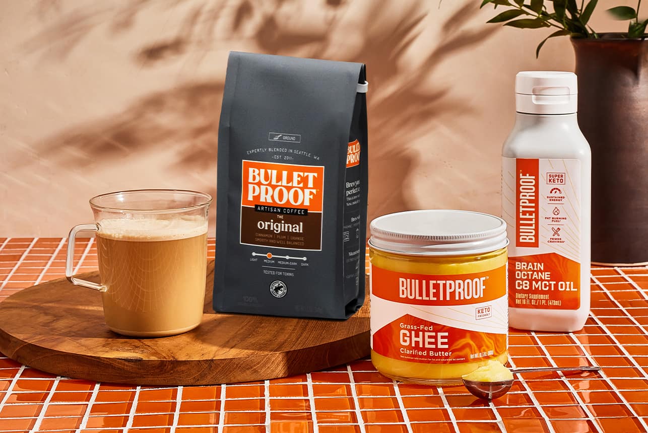 Cup of brewed coffee, Bulletproof coffee beans bag, Bulletproof Ghee and Bulletproof MCT oil