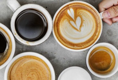 Cups of coffee shot overhead filled with espresso, drip coffee and lattes