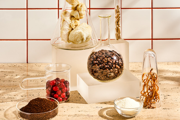 Different mushroom types, coffee berry and coffee beans in test tubes