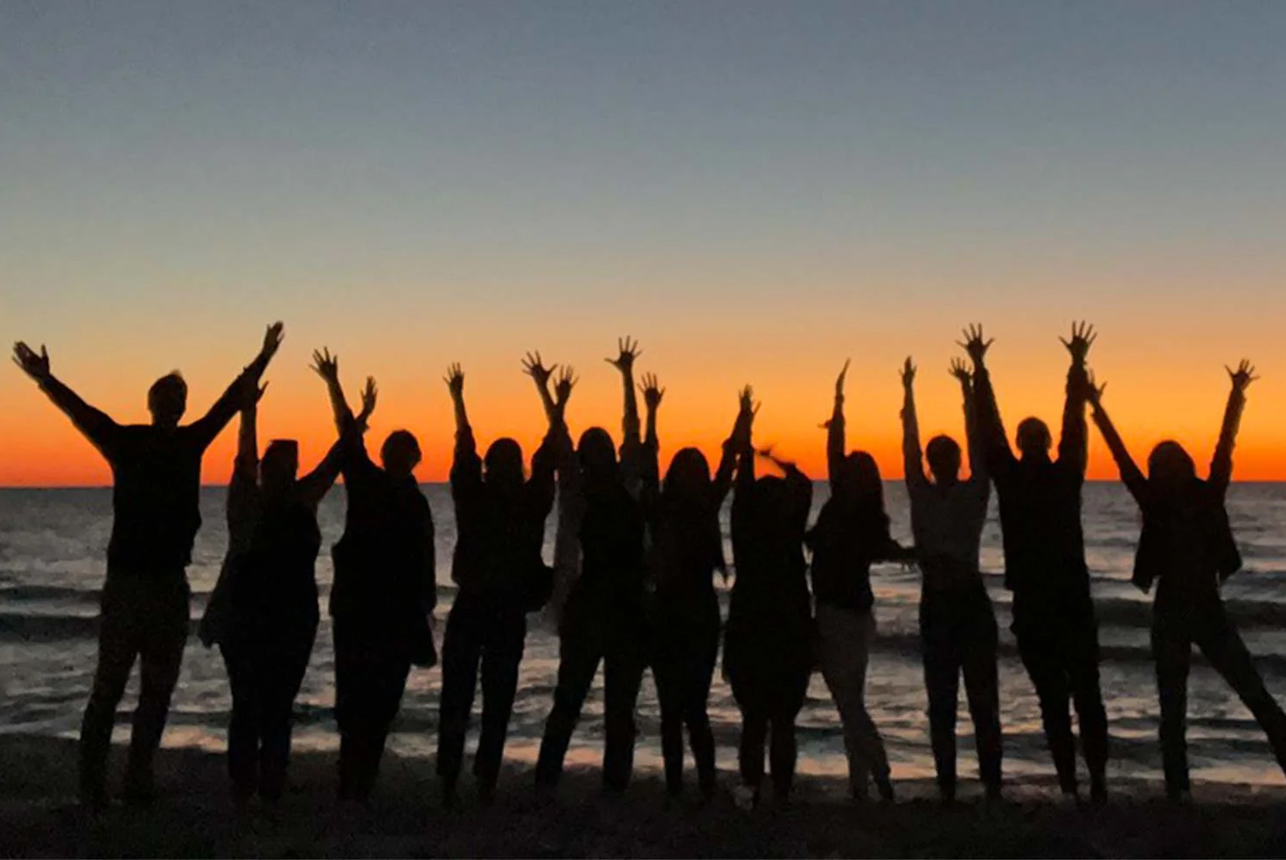Bulletproof employees at the beach during sunset