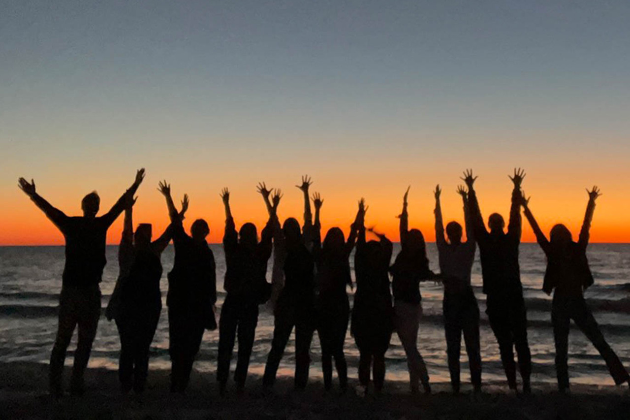 Bulletproof team members at beach during sunset