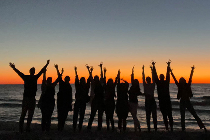 Bulletproof team members on beach at sunset