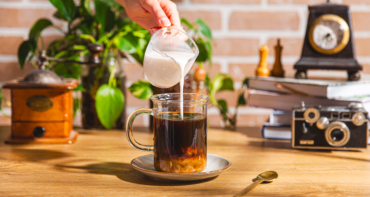 pouring protein cream into coffee